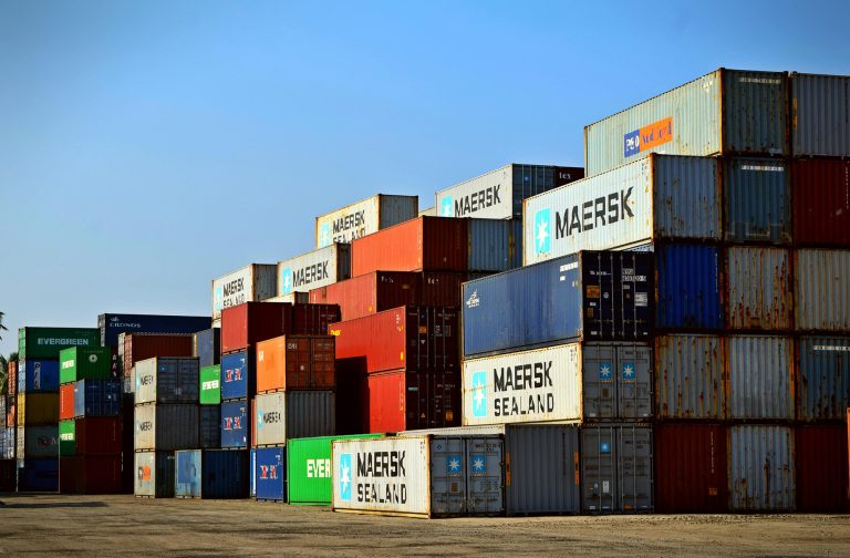 Shipping containers stacked in ship yard